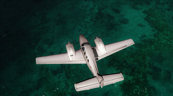 An airplane flying high above coral waters.