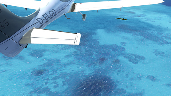 A small plane flying over coral waters in the ocean.