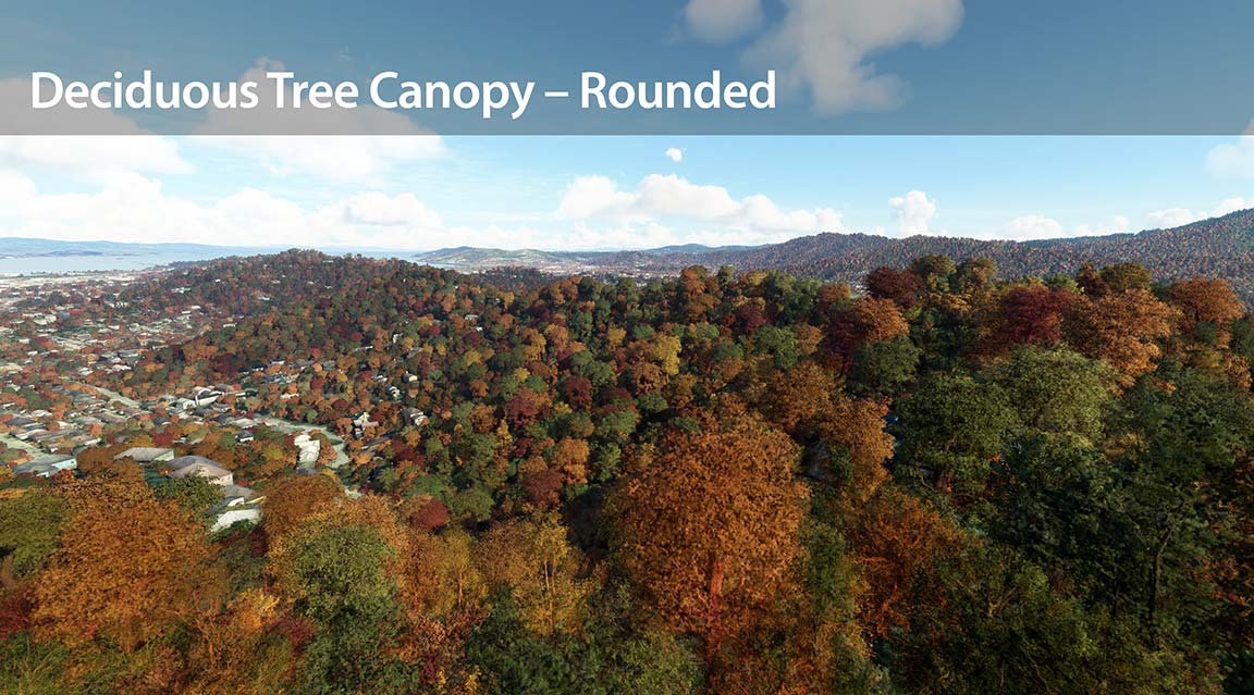 A city skyline with lush trees and towering mountains in the distance.