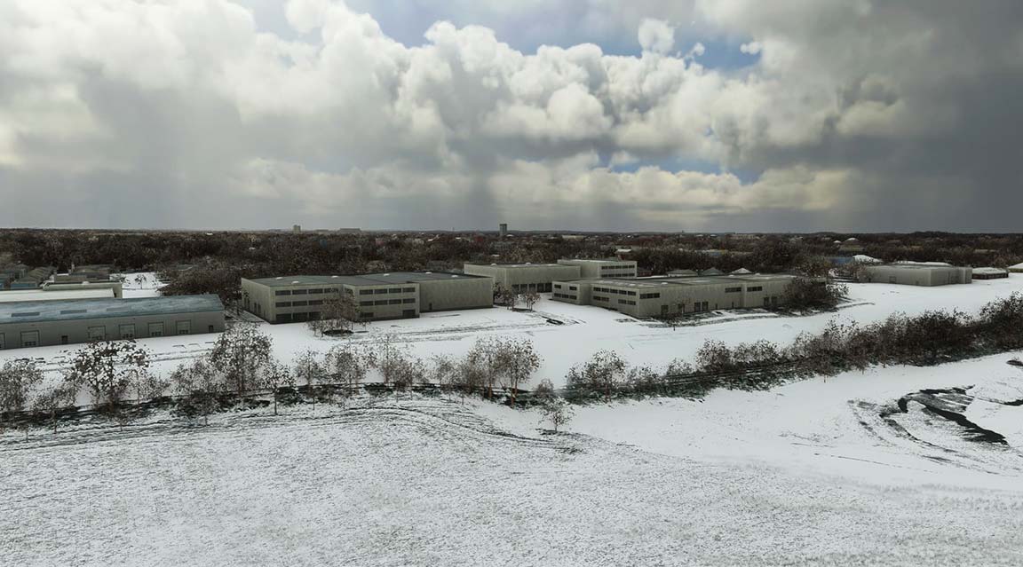 Aerial view of snowy field with leafless trees in winter landscape.