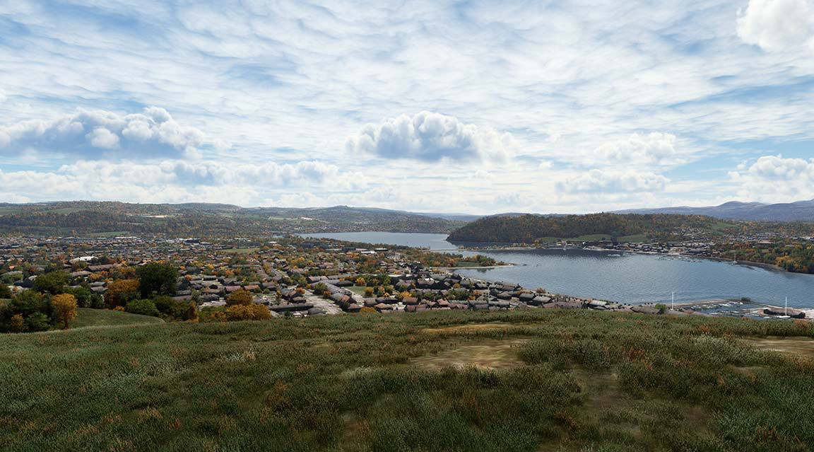 Scenic view of city, lake, and mountain in the distance.
