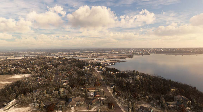 Cityscape with trees and water visible in the background.