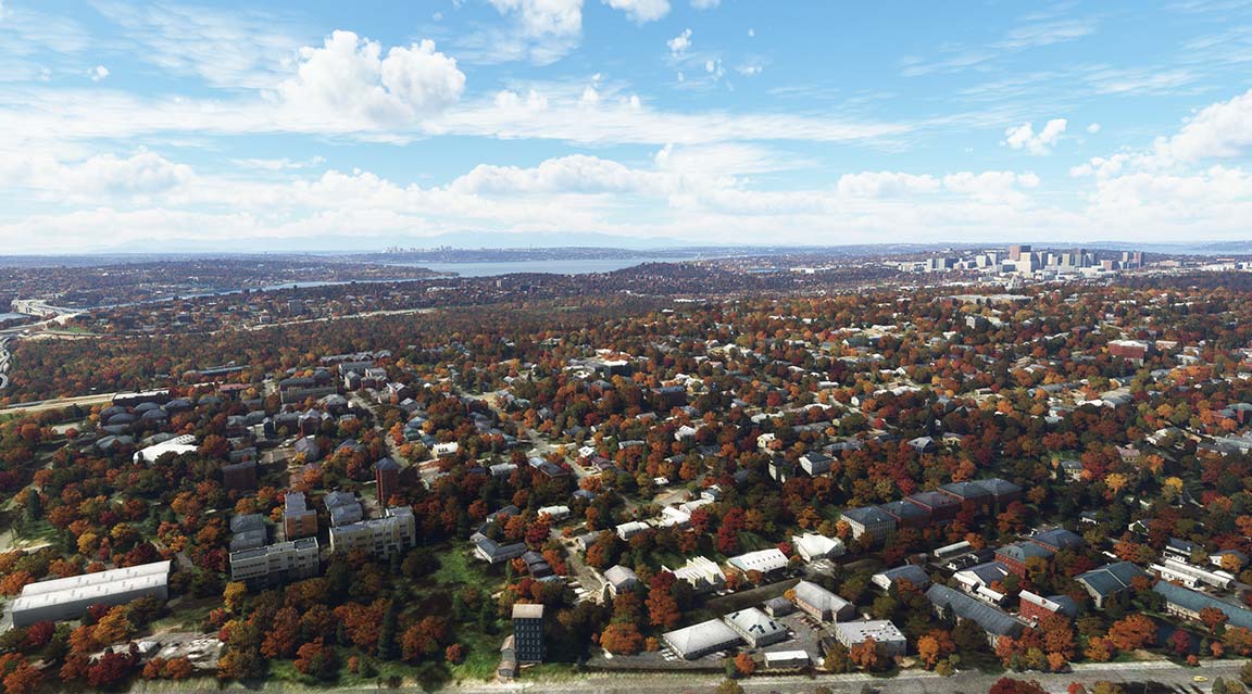 Urban area with autumn trees and structures during cloudy weather.