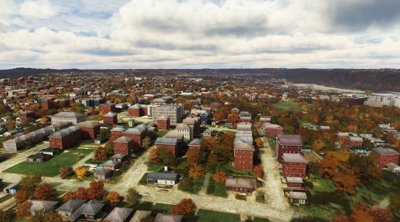 Urban landscape with tall buildings and a variety of trees.
