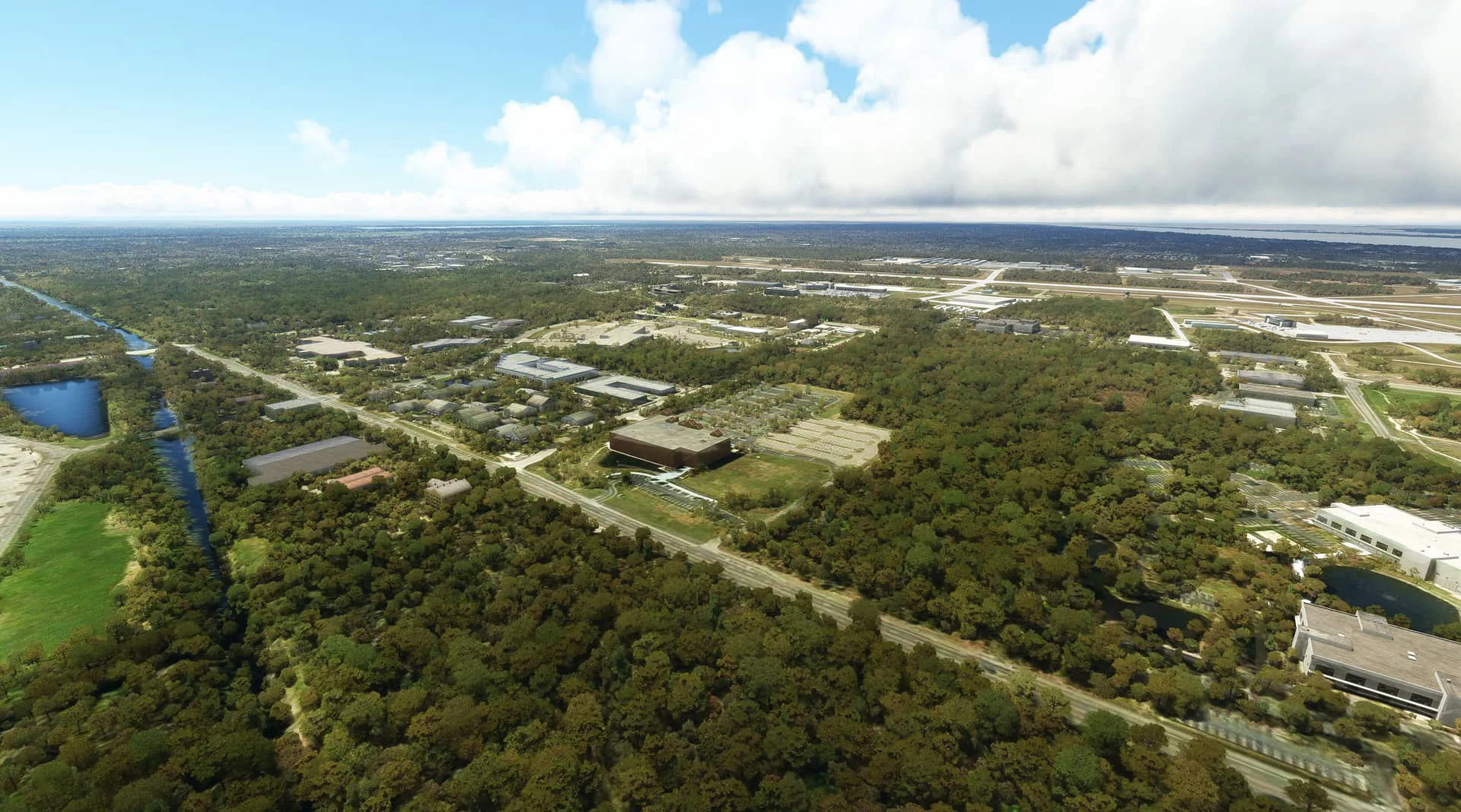 Aerial view of lush green forests and terrain near an airport, rendered with REX AccuSeason Advanced Edition