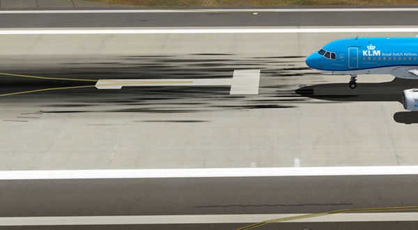A blue airplane parked on the runway.