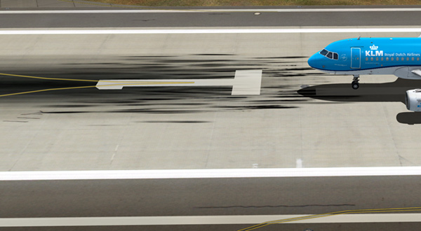 A blue airplane parked on the runway.