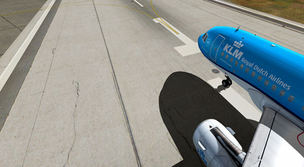 A blue airplane parked on the runway.