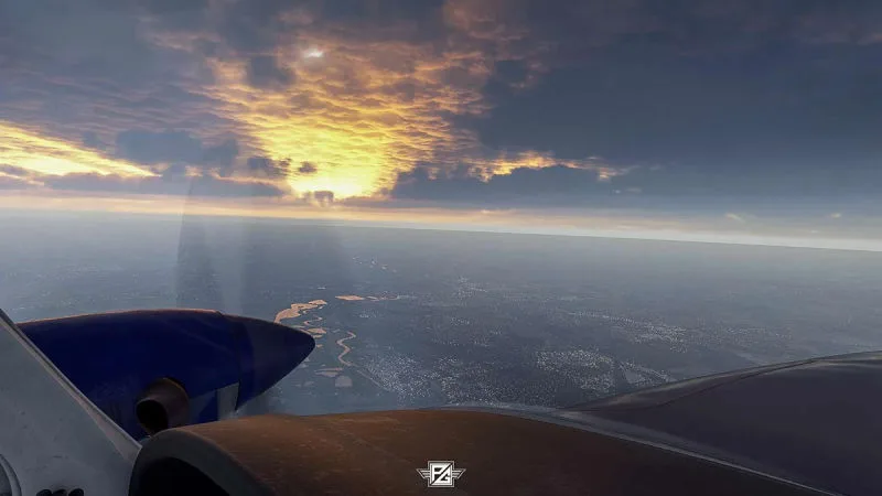 Twin-engine aircraft over a river beneath fiery sunset clouds, REX Atmos CORE cloud lighting in Microsoft Flight Simulator 2024