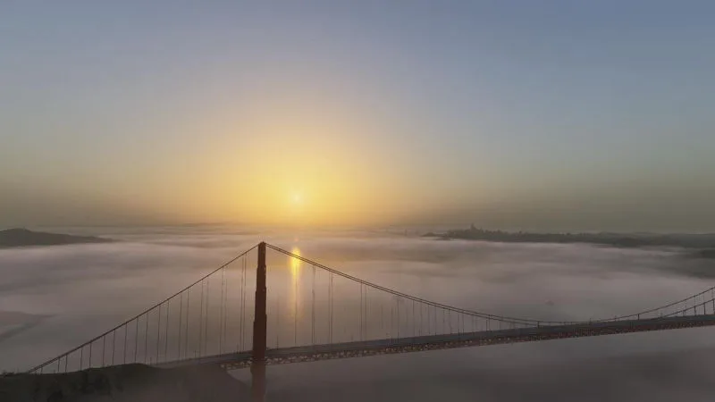 Golden Gate Bridge rising above low fog at sunrise, REX Atmos CORE atmospherics in Microsoft Flight Simulator 2024