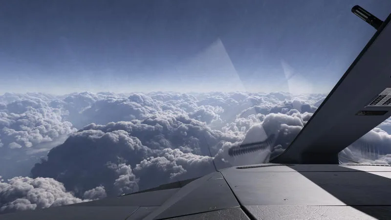 View past the tail over towering cumulus cloud layers, REX Atmos CORE volumetric clouds in Microsoft Flight Simulator 2024