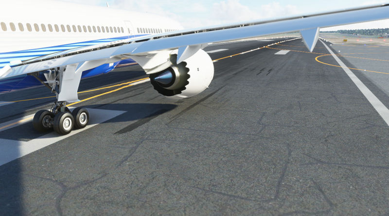 A large airplane with landing gear down on the runway.