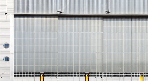 A spacious airport hangar with a sizable window.