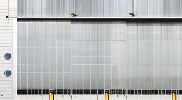 A spacious airport hangar with a sizable window.