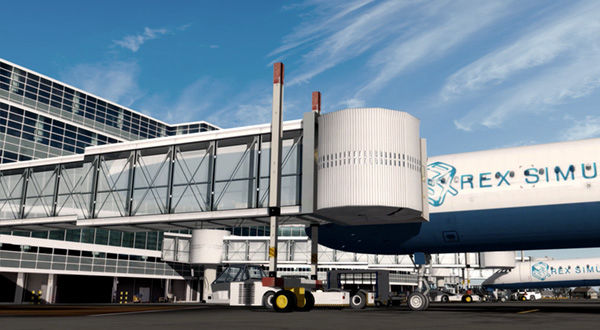 A large blue and white airplane parked at an airport terminal with jetway.