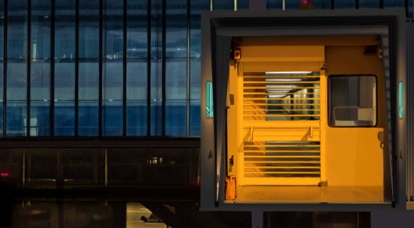 Exterior view of airport terminal with yellow door and window.