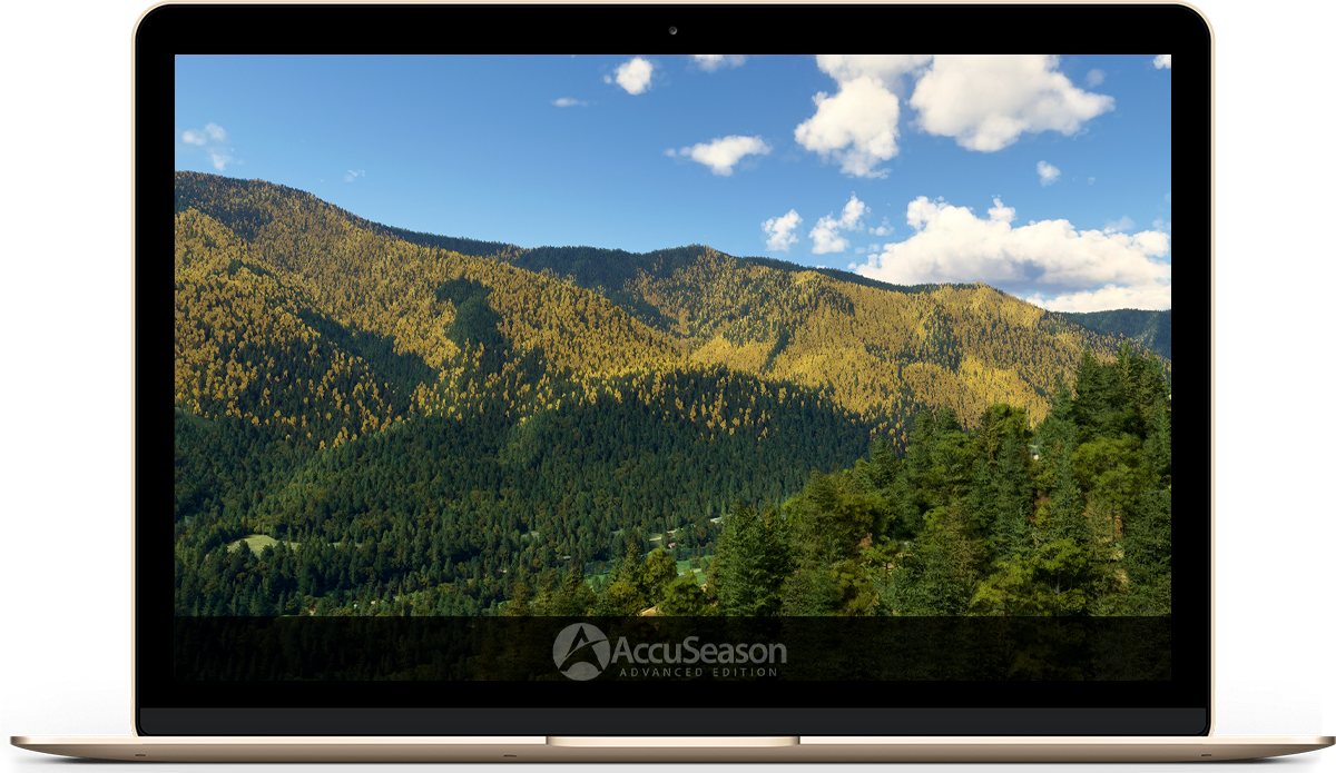 A computer on a desk with a stunning mountain view in the background.