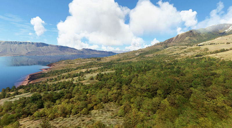 A peaceful lake with mountains in the background.