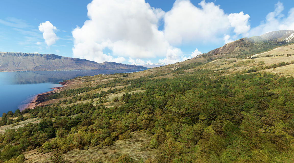 A peaceful lake with mountains in the background.