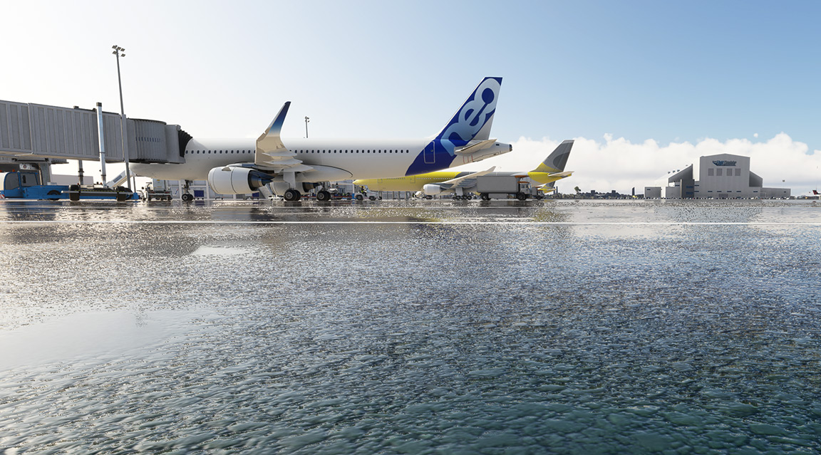An aircraft sitting on a rain-soaked tarmac.