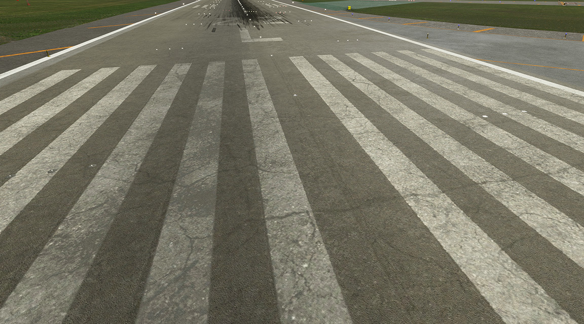 An airport runway with a plane preparing for takeoff.