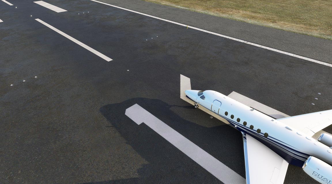 A small airplane parked on a runway, ready for takeoff.
