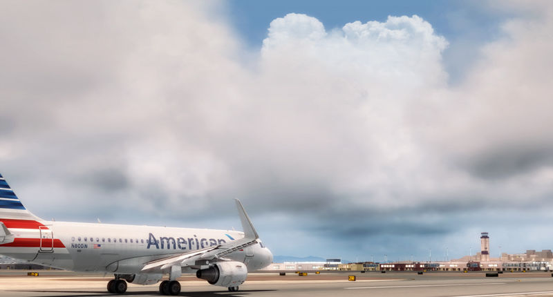 American Airlines jet parked on airport tarmac.