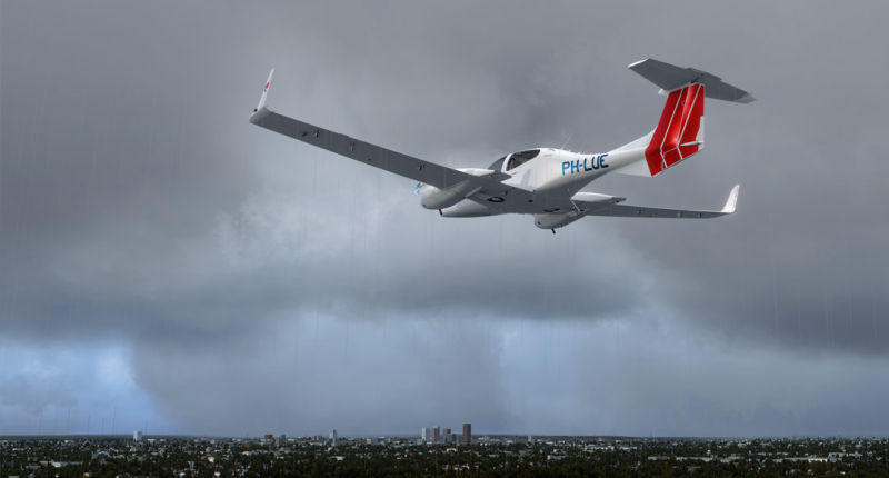 A small plane flying over a city on a cloudy day with rain shafts.