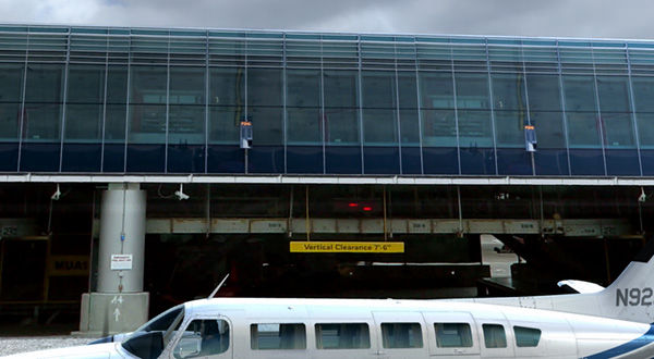 Small plane parked in front of airport terminal building.