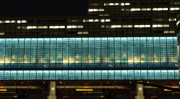 A large airport terminal building with rows of windows.
