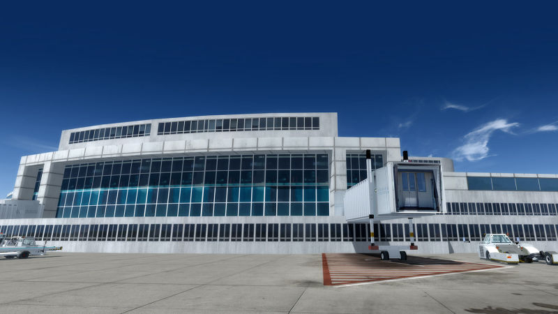 A large airport building on a sunny day.