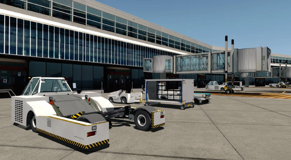 An airport pushback truck parked in front of a building.
