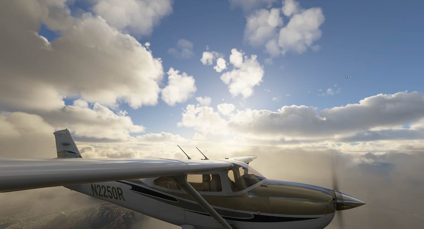 Small aircraft soaring above fluffy clouds.